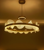 Decorative ceiling light fixture with a warm glow on a neutral background