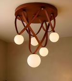 Ceiling light fixture with wooden design and multiple round lights on a neutral background