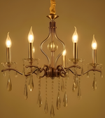 Gold chandelier with crystal accents on a gold background