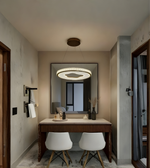 Modern bedroom with vanity table, chairs, and decorative elements.