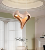 Modern pendant light hanging in a stylish room with large windows and decorative elements.
