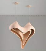 Modern pendant light with a unique, wavy design on a gray background