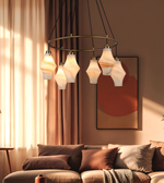 Modern circular ring chandelier featuring multiple marble-effect glass pendant lights with brushed brass accents and warm ambient illumination.