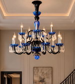 Close-up of a luxury chandelier featuring blue decorative accents, a black frame, and clear crystal-style hanging ornaments.