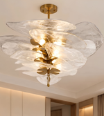 Artistic chandelier featuring layered translucent glass petals and warm illumination.