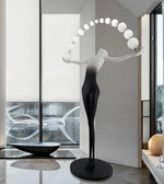 Sculptural floor lamp by Daya Worldwide featuring a modern, artistic statue design with a sleek base and ambient lighting.