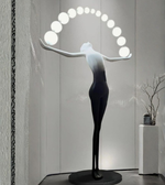 Sculptural floor lamp from Daya Worldwide's Aura Balance collection, featuring a modern statue design with a sleek metal finish.