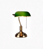 Green banker desk lamp with brass base isolated on white background