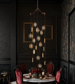 Luxurious dining room with a hanging chandelier and dark walls.