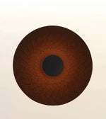 A circular brown textured mat or rug with a dark brown to black center, shown against a plain off-white background.