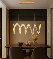 Sculpted wave crystal LED dining pendant light above a modern dining table interior