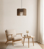 Acoustic felt pendant light above minimalist lounge setup with beige tones
