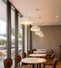 Drift White Foam Pendant with cloud-like sculptural shape above dining and café interiors.