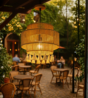 Bohemian rope pendant light with tassels hanging over outdoor café seating