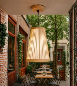 Natural bamboo pendant ceiling light adding warm illumination to a cozy patio.