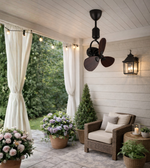 Decorative mini ceiling fan with wooden blades installed in a balcony sit-out area