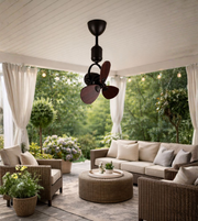 Decorative mini ceiling fan with wooden blades installed in a balcony sit-out area
