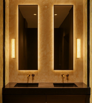 Crystal Bubble Vanity Wall Light installed vertically beside twin mirrors in a luxury bathroom with warm lighting.