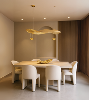 Elegant linear pendant light called THE GOLDEN WAVE by Daya Worldwide, featuring a sleek gold wave design for modern decor.