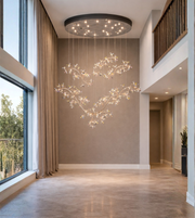 Luxury crystal blossom chandelier with gold branches installed in double height 
