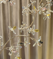 Luxury crystal blossom chandelier with gold branches installed in double height staircase area