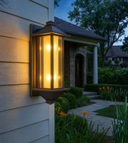 Heritage-inspired outdoor wall light glowing beside a home entrance.