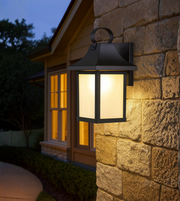 Traditional metal and glass outdoor wall lantern for porch lighting.