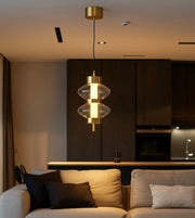 Modern gold and glass pendant light above beige sofa in contemporary living room