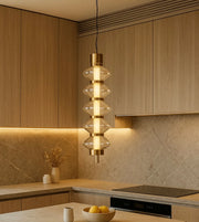Modern gold pendant light with glass accents in a contemporary wood kitchen setting