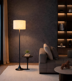 Modern fabric shade floor lamp beside sofa creating warm ambient lighting in cozy living room interior
