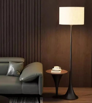 Modern fabric shade floor lamp beside sofa creating warm ambient lighting in cozy living room interior