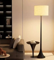 Modern fabric shade floor lamp beside sofa creating warm ambient lighting in cozy living room interior