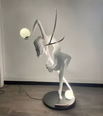 Illuminated dancer sculpture floor lamp by Daya Worldwide, featuring a graceful statue with integrated lighting for modern decor.