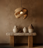 Clay spiral pendant light handcrafted from foam with warm earthy finish.