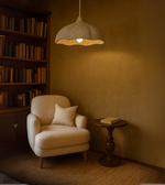 Modern Earth Wave pendant lamp in white textured finish above a cozy seating area
