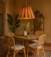 Terra Rustic Pendant Light with earthy fluted shade hanging above a round dining table.