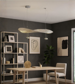Daya Worldwide Golden Wave linear pendant light with sleek gold finish, modern design, hanging from ceiling with warm illumination.