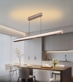 Strato Linear frosted crystal LED pendant suspended over minimal dining area.