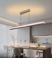 Strato Linear frosted crystal LED pendant suspended over minimal dining area.