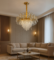 Royal Crest gold chandelier with crystal beads and drops hanging in a luxury seating area