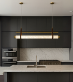 Axis Marble Linear Light in brushed gold and marble finish illuminating a modern kitchen
