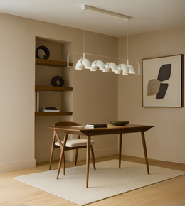 Arcus Linear Pendant Light with dome diffusers suspended above a dining table
