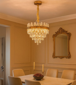 Opulent Orb gold circular chandelier with crystal drops illuminating a luxury dining room.