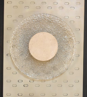 Modern stone halo wall light by Daya Worldwide, showcasing a sleek circular design with a soft glow on a contemporary wall.
