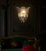 Luxury crystal petal wall sconce with cascading glass elements lighting up a dark classical interior