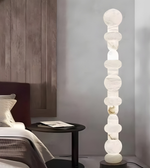 Luxury marble standing lamp beside bed creating soft ambient lighting