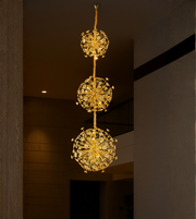Dandelion Dream gold crystal chandelier with triple bloom design for tall ceiling interiors.