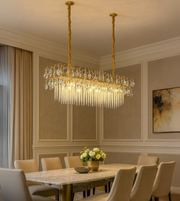 Regalia Linear Crystal Cascade chandelier with gold frame and crystal waterfall design for a luxury dining room.