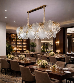 Crystal leaf luxury dining chandelier with warm lighting installed in a fine dining restaurant interior