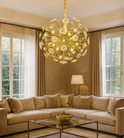 Solis Orb gold chandelier resembling sunburst design in a modern living area.